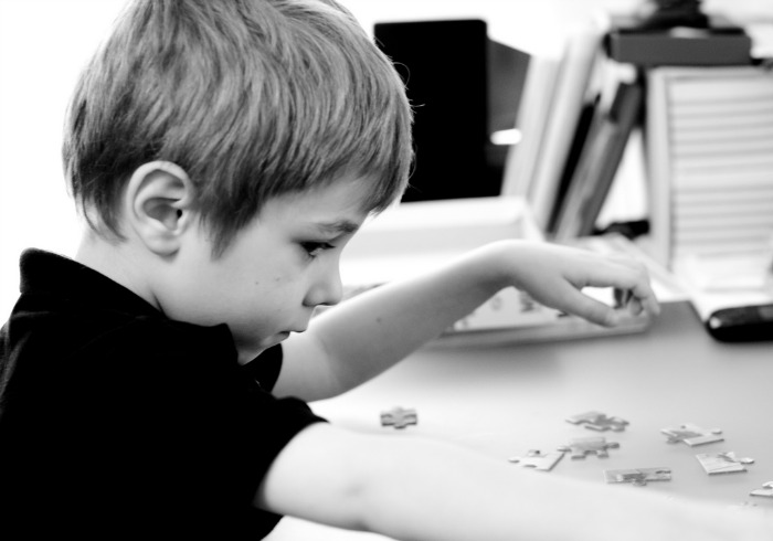 kid doing puzzle